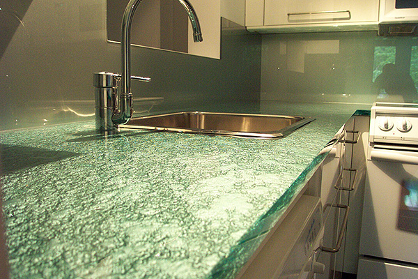 For a high-styled effect, the glass can placed over stainless countertops.
